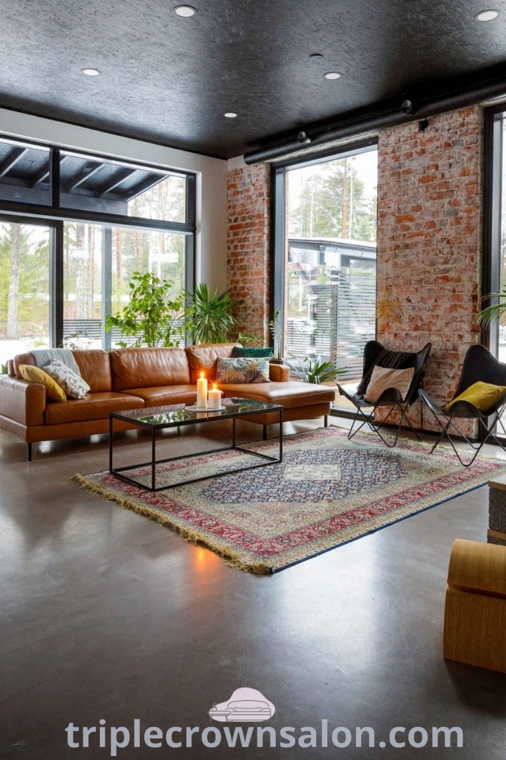 A cozy red brick interior living room filled with furniture, large windows, and a fireplace. This inviting space showcases decor ideas for brick interiors, offering unique design trends and inspirations for your home. Visit triplecrownsalon.com for more cozy home ideas.