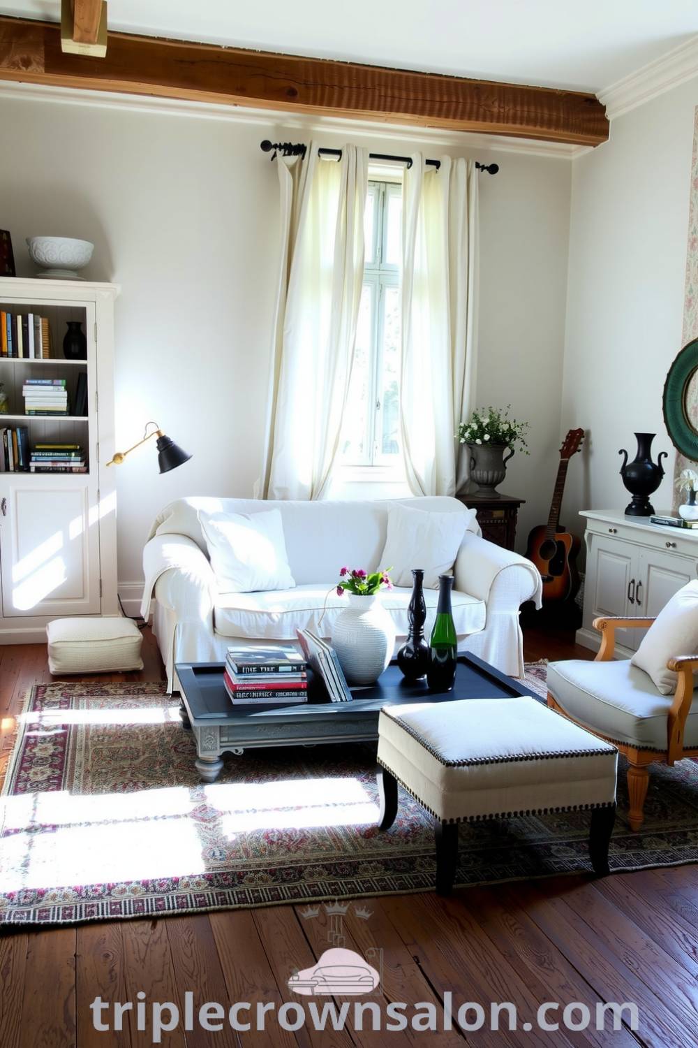 French living room featuring cream-colored walls, weathered oak flooring, a plush overstuffed sofa, vintage armchairs, sheer curtains, decorative vases, and a handcrafted rug, showcasing cozy ideas and design inspirations for your home at triplecrownsalon.com.