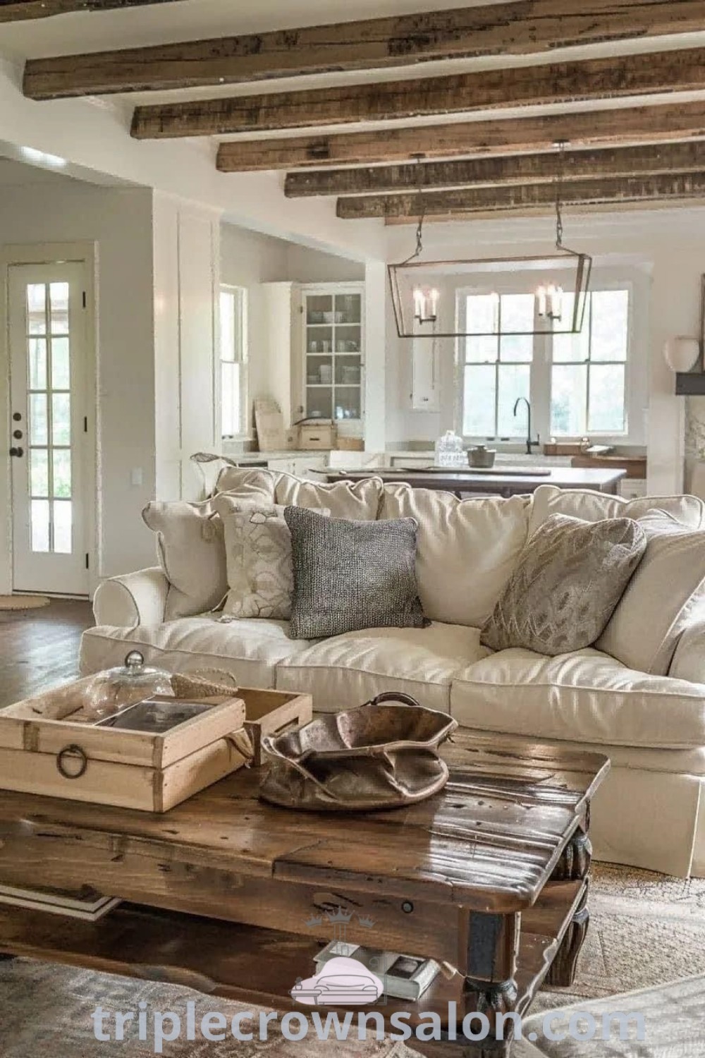 A cozy cottage farmhouse living room filled with rustic furniture and large windows, showcasing modern country living designs and decor inspirations. This inviting space offers cozy ideas and decor tips for your home, blending comfort with style. Explore more at triplecrownsalon.com.