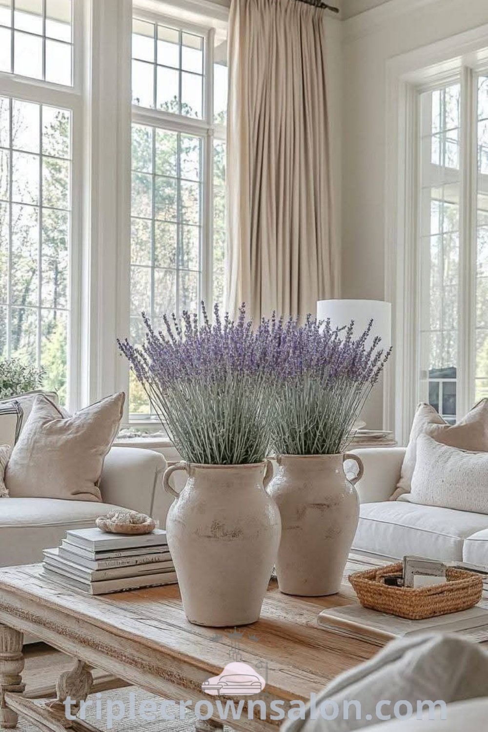 A cozy French Country living room featuring white furniture, large decorative vases on a coffee table, and inviting design inspirations for apartments or houses. This decor embodies a unique blend of comfort and elegance, ideal for those seeking cozy ideas for their home. Explore more decor ideas at triplecrownsalon.com.