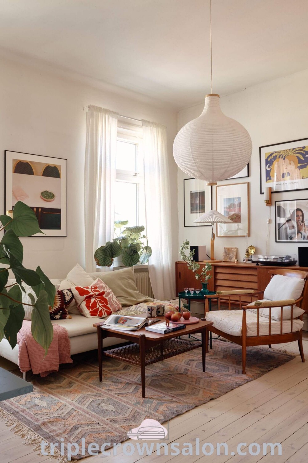 A cozy Scandinavian living room filled with stylish furniture, pictures on the wall, and a window allowing natural light, showcasing design ideas for small spaces and apartment inspiration. Discover more decor inspirations at triplecrownsalon.com.
