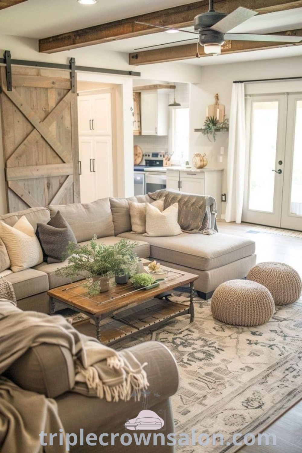 A cozy farmhouse living room showcasing stylish furniture, a large wooden barn door, and inviting decor elements that combine modern farmhouse living with functional beauty. Discover design ideas and inspirations for your home at triplecrownsalon.com.