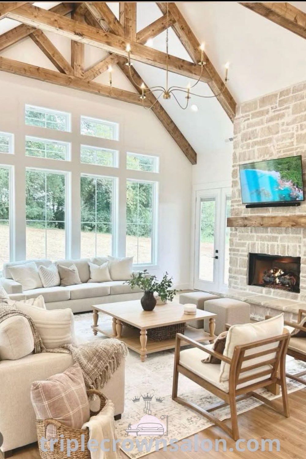 A cozy modern farmhouse living room filled with stylish furniture and a flat-screen TV above the fireplace, designed for comfort and aesthetics. Explore unique ideas and decor inspirations for your home at triplecrownsalon.com.