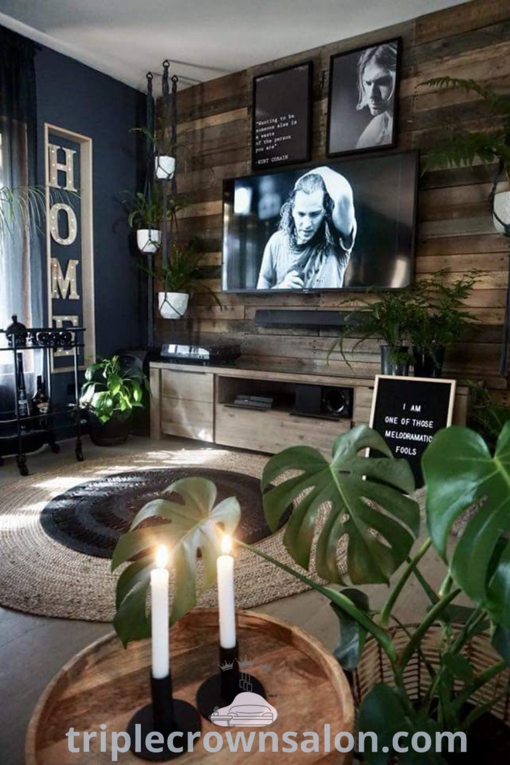 An industrial rustic living room filled with furniture and a flat screen TV mounted on the wall, showcasing dark home decor and minimalist design ideas, perfect for small spaces. Explore decor inspirations at triplecrownsalon.com.