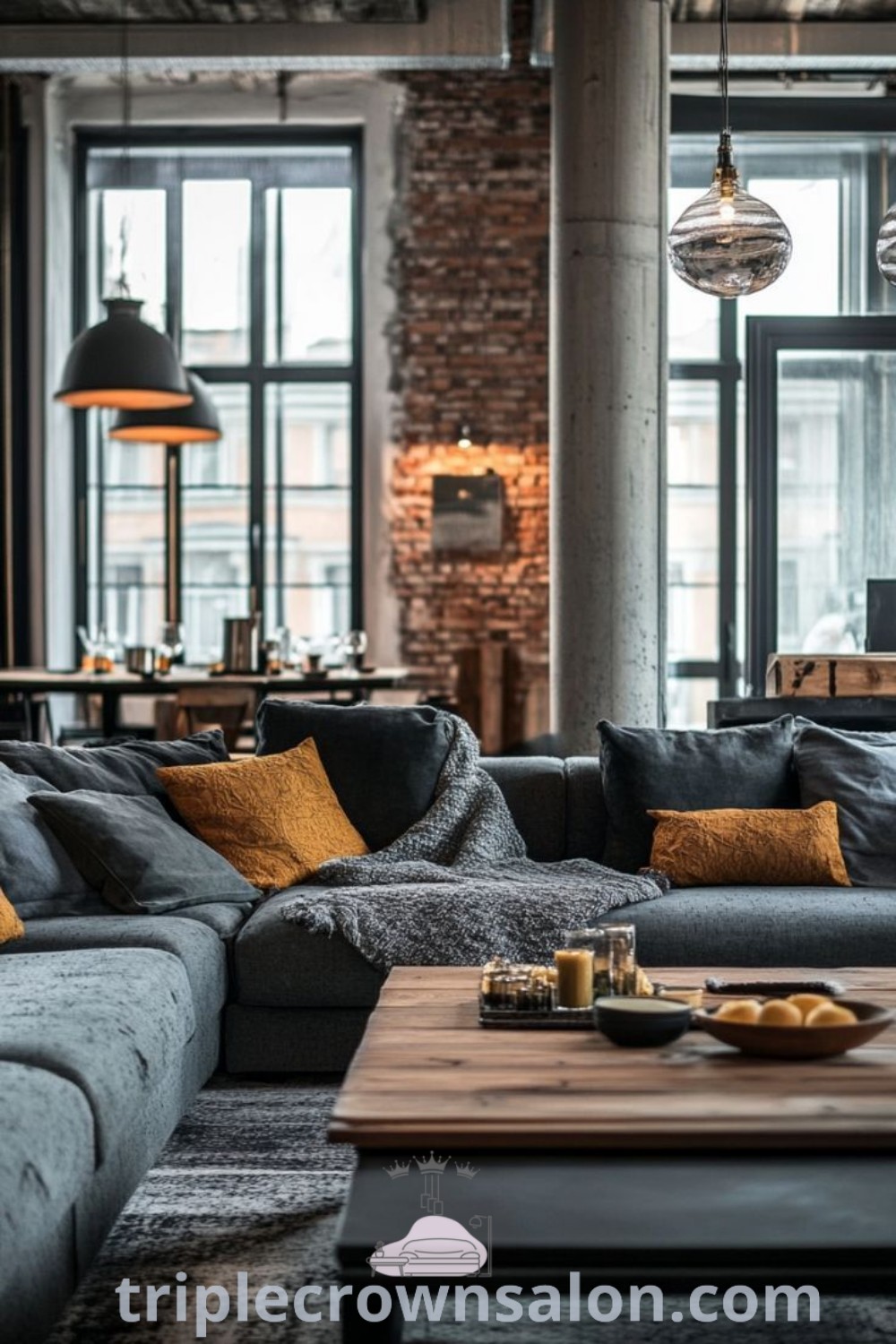 An industrial chic living room with oversized lighting, an exposed brick wall, and a cozy aesthetic. The design incorporates Edison bulbs and unique decor ideas, offering inspiring tips for creating a stylish and comfortable home. Discover more inspiring ideas at triplecrownsalon.com.