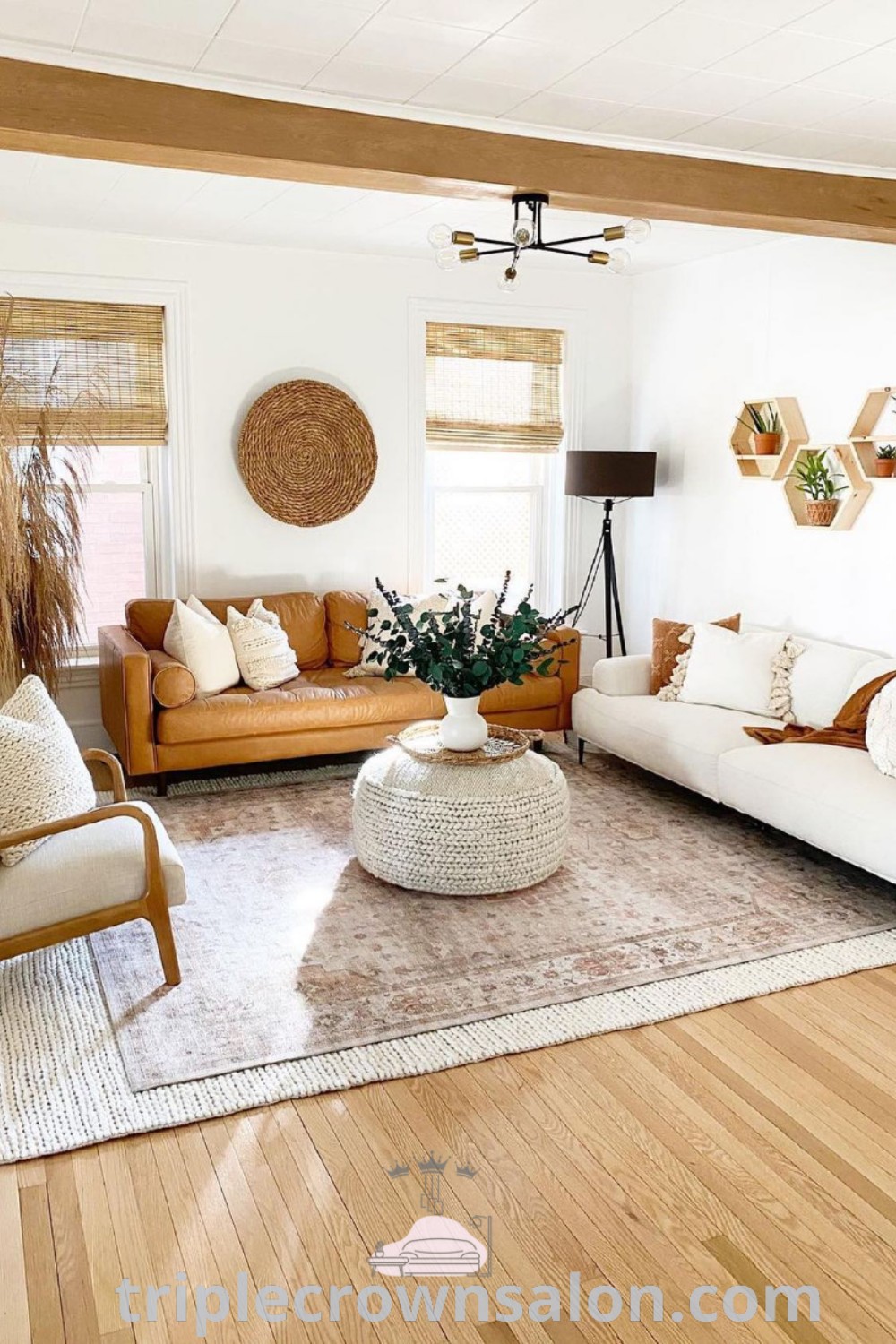 A modern Boho living room designed for warmth and comfort, featuring cozy decor ideas and inviting designs suitable for an apartment. This stylish space offers unique ideas and inspirations for your home. Discover more at triplecrownsalon.com.