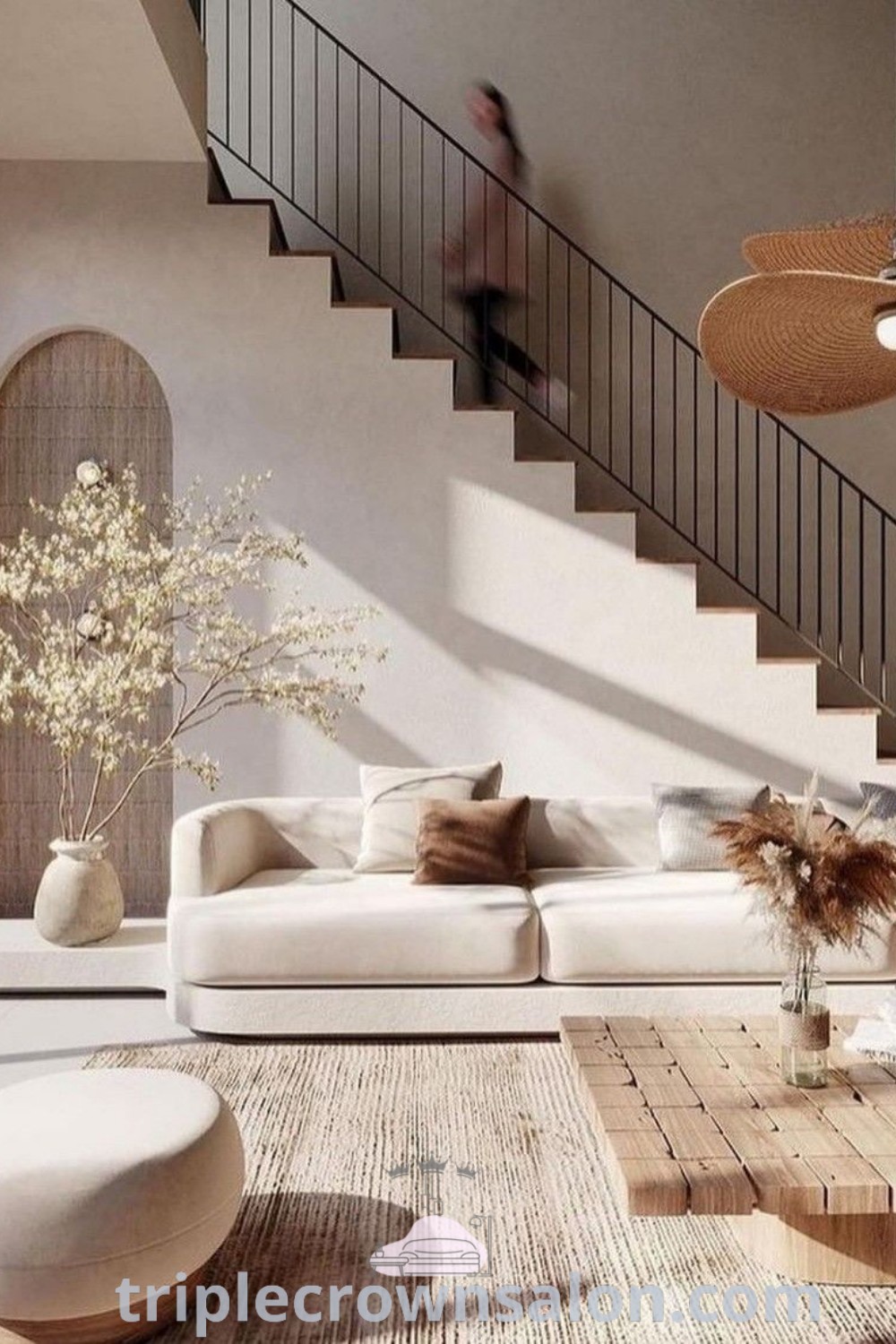 A beautifully designed Japandi living room featuring cozy decor, a functional layout, and a staircase in front of a large window, showcasing Japandi interior design ideas. This inviting space offers unique decor inspirations for small spaces and cozy aesthetics. Explore more unique ideas for your home at triplecrownsalon.com.