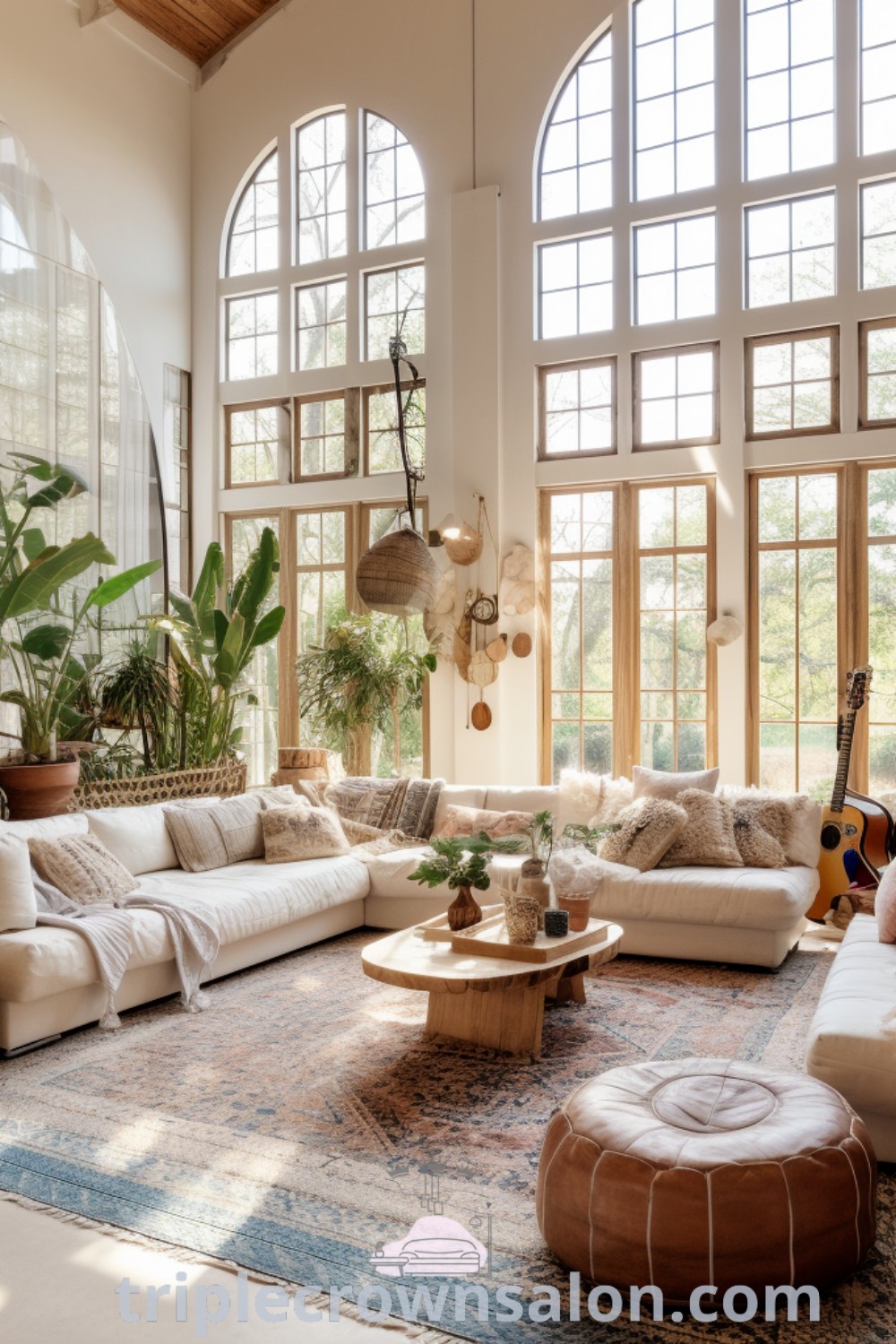 A bright and spacious living room with large windows, cozy furniture, and Mediterranean boho decor. The image showcases unique ideas for a big living room filled with house plants and aesthetic touches, making it an inspiring space. Discover more design ideas at triplecrownsalon.com.