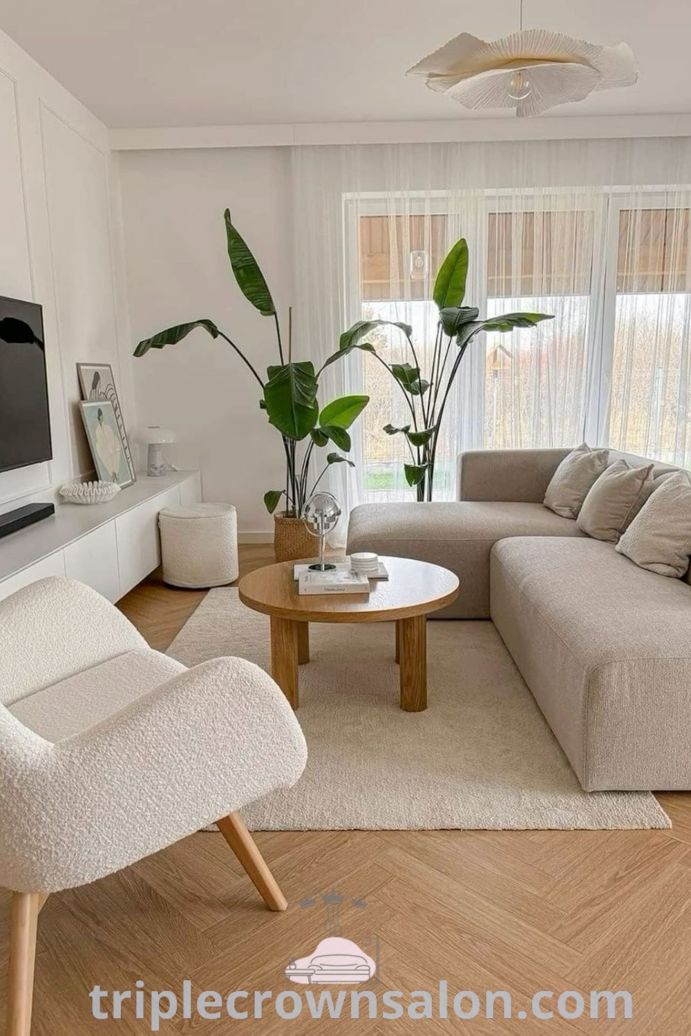 A cozy living room filled with stylish furniture and a flat screen TV, embodying inviting decor ideas and the cozy aesthetic. This design inspires unique ideas for your home, perfect for house or apartment living. Explore more inspirations at triplecrownsalon.com.