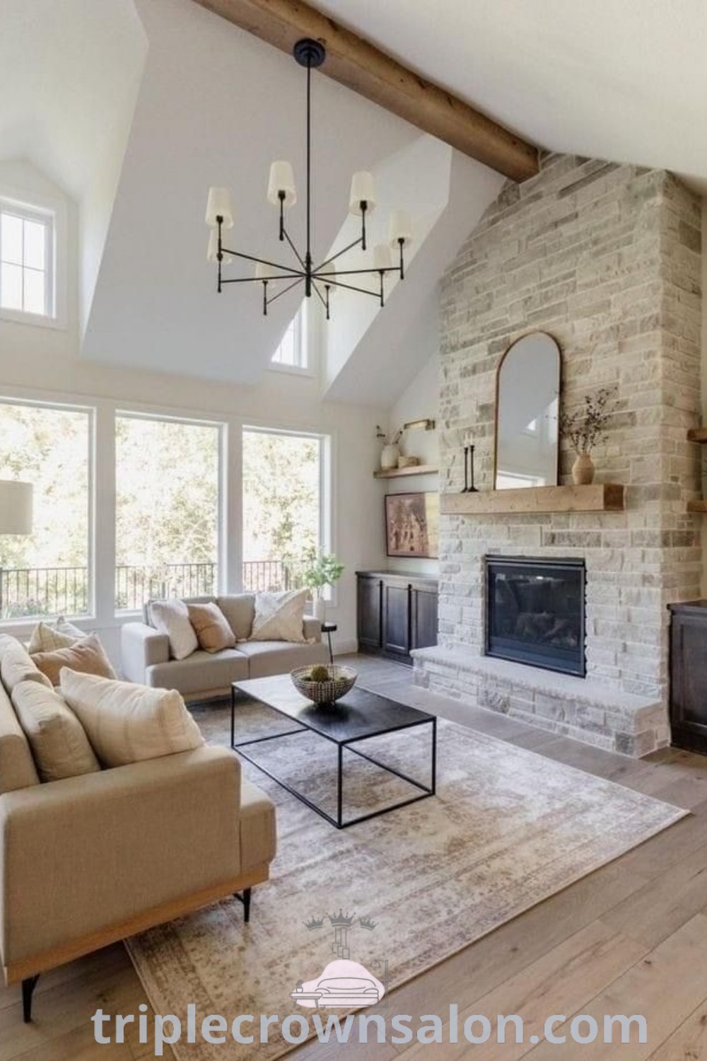 A cozy open floor plan living room featuring furniture arranged around a central fireplace, offering a perfect blend of aesthetic appeal and functionality. Explore unique ideas for family room windows and decor inspirations at triplecrownsalon.com.