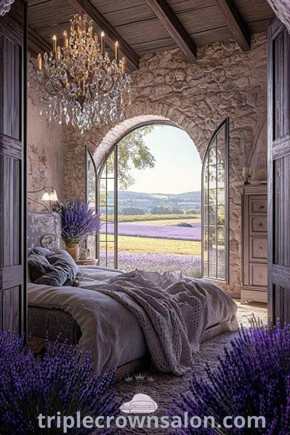 A cozy French farmhouse bedroom showcasing an arched window with lavender flowers in the foreground and a hanging chandelier. This decor embodies French house aesthetic inspirations, offering unique ideas for creating a stylish, inviting space in your home. Explore more design ideas at triplecrownsalon.com.