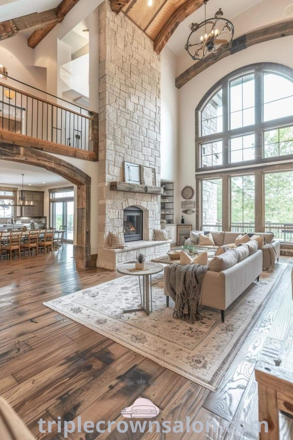 A large living room with high ceilings and wood flooring, featuring a barndominium interior that embodies modern barn house designs. This cozy space reflects unique ideas and decor inspirations for your home, showcasing a blend of style and functionality. Explore more with triplecrownsalon.com.