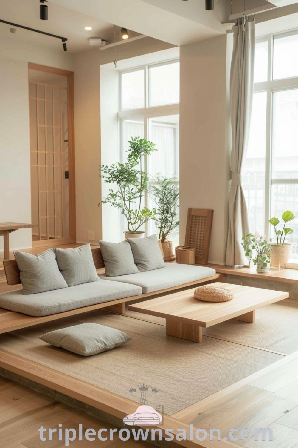 A Zen-inspired living room filled with Scandinavian decor ideas, featuring large windows, potted plants, and cozy furnishings. This cozy home setup combines Japandi living and modern apartment decor, providing unique ideas and inspiring suggestions for your space. Discover more design ideas at triplecrownsalon.com.