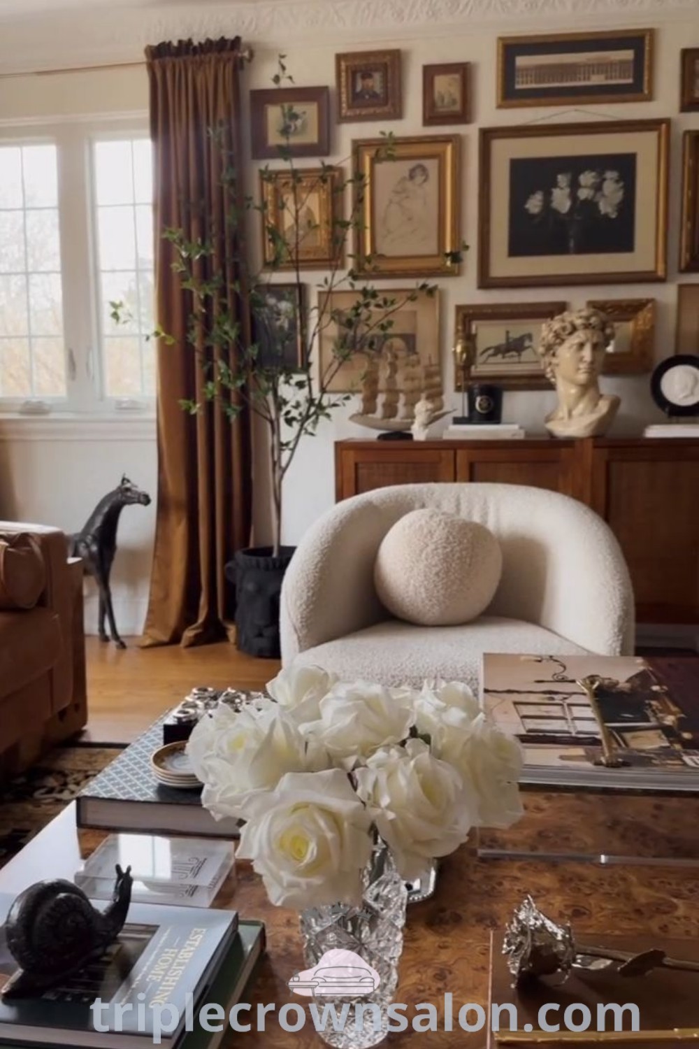An eclectic antique living room featuring cozy traditional decor, romantic vintage elements, and upscale modern furniture. This inspiring layout offers practical tips on how to hide doors and showcases design ideas to enhance your home. Discover more design trends and inspirations at triplecrownsalon.com.