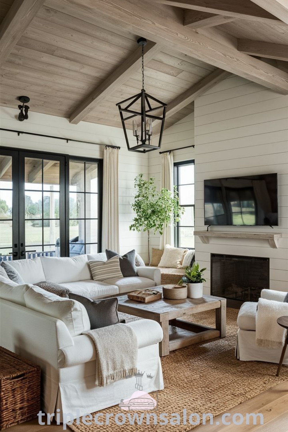 A stylish living room filled with elegant furniture, a flat-screen TV mounted above a cozy fireplace, embodying Florida luxury home interiors and Western chic decor, offering inspiring ideas for your home. Perfect for cozy living, explore unique design ideas and decor inspirations at triplecrownsalon.com.