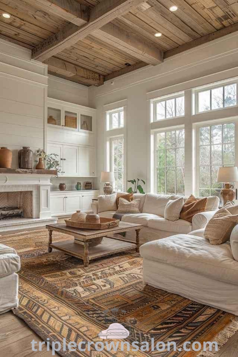 A warm and inviting farmhouse living room featuring furniture around a fireplace, with two windows and a wooden floor. This cozy space showcases modern rustic decor and provides design tips for inspiring ideas for your home. Explore unique decor ideas for small spaces and cozy aesthetics at triplecrownsalon.com.