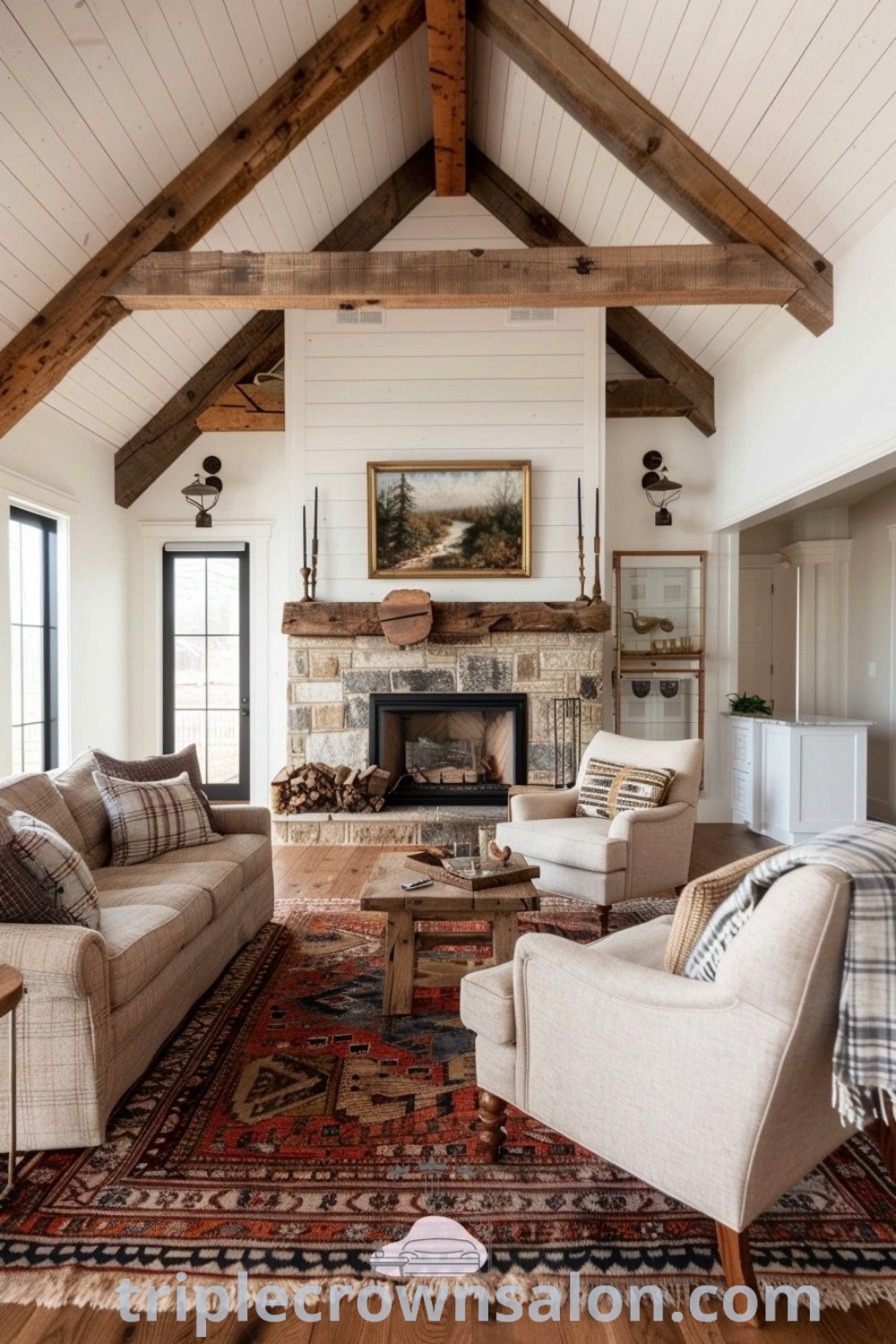 A modern farmhouse living room with two couches, a cozy rug, and a shiplap fireplace, showcasing vaulted ceiling decor ideas. This inviting space offers design inspirations and unique ideas for your home. For more cozy home inspirations, visit triplecrownsalon.com.