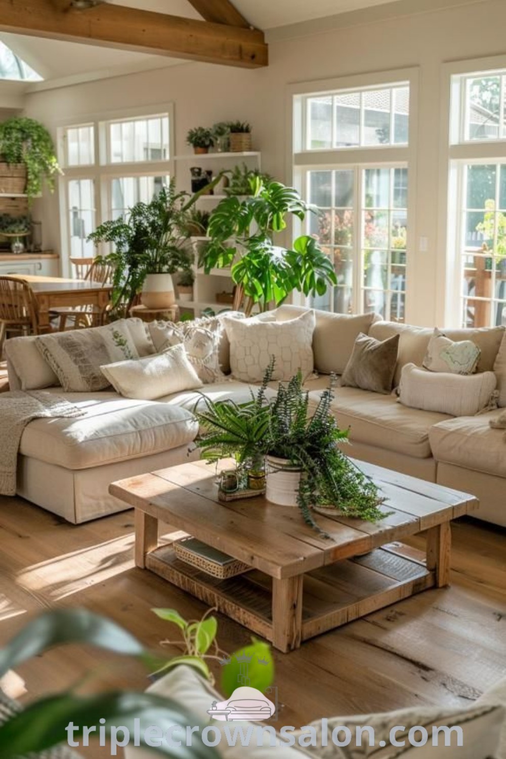 A cozy country living room filled with furniture and plants atop wooden flooring, showcasing inspiring decor ideas that combine comfort and style. Discover unique ideas and inspirations for your home at triplecrownsalon.com.